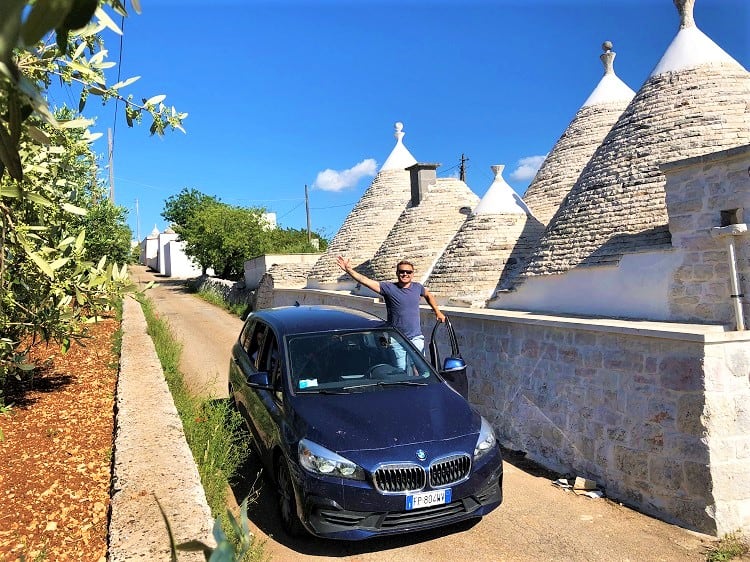 Alberobello, Italy, man, car and houses