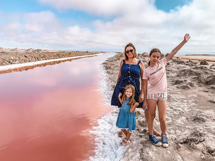 Visit Pink Salt Lakes in Swakopmund with Kids, mother and daughter standing on the side of the lake smiling
