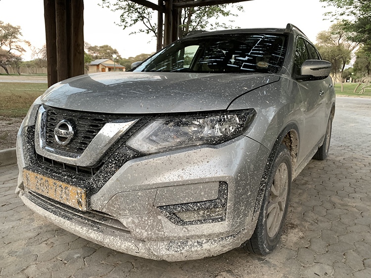 Car with dirt on it after driving in the desert in Etosha National Park in Namibia