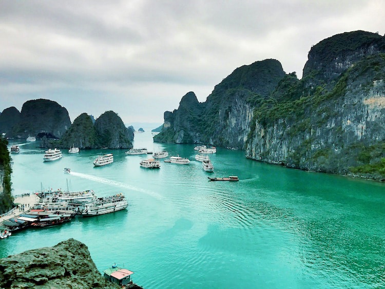 Halong Bay, Vietnam, view of the junk boats in water from the top, bay and rocky islands surrounding 