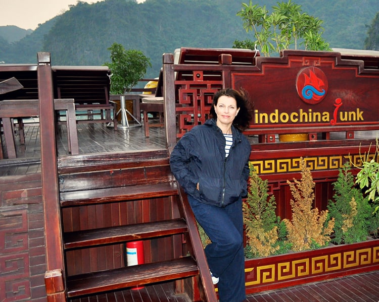 Indochina-Junk-Halong-Bay, Vietnam, woman in warm clothes posing on the deck