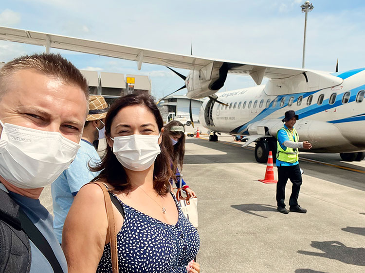 How to get to koh samui, Thailand, a couple and some tourists in front of the plane