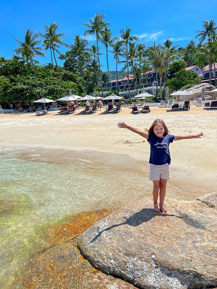 Chaweng Noi, Koh Samui, Thailand, young girl standing with arms up, in front of the resort, palm trees