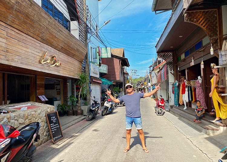 Fisherman's Village in Koh Samui, BoPhut Thailand, man standing in the street, shops, scooters, restaurants