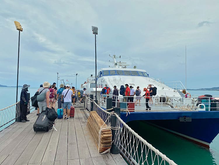 How To Get To Koh Phangan From Koh Samui, Thailand, people boarding the boat, ferry, tourists pulling luggage