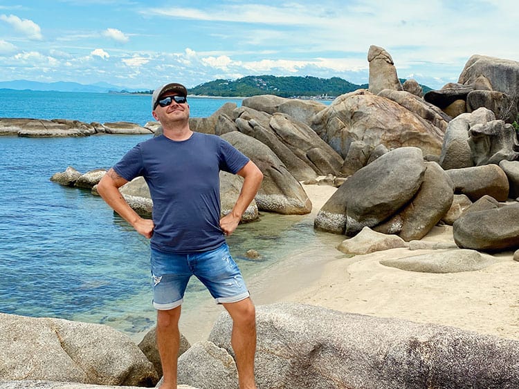 Hin Ta And Hin Yai Rocks, Thailand, penis rock, man standing proud on the beach, rocks in background