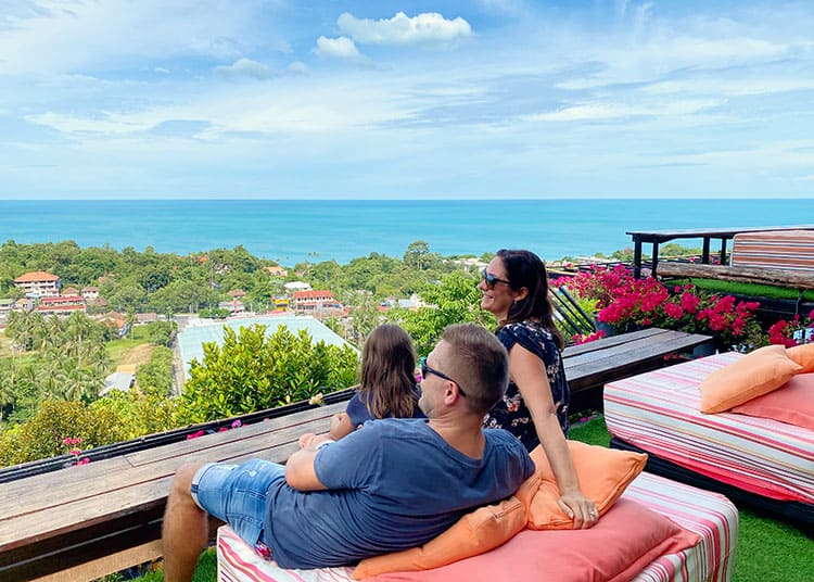Lamai Viewpoint, Koh Samui, Thailand, family sitting on the day beds looking from the top of the mountain towards the view, ocean in background