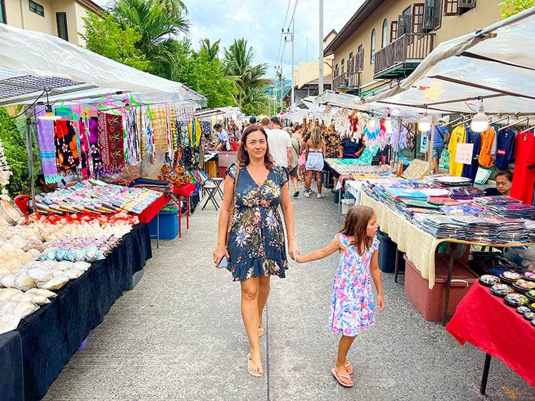 Night Markets in Koh Samui, Thailand, mother and daughter walking in the markets, dozens of stalls, tourists