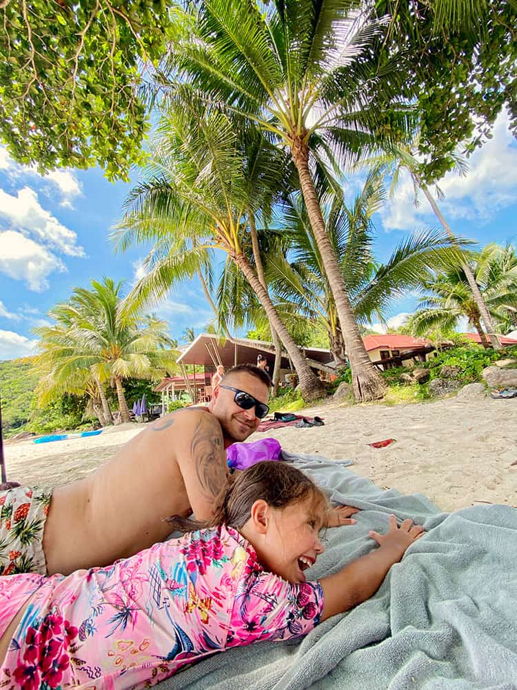 What is the most beautiful beach in Koh Samui, Silver Beach, Koh Samui, Thailand, father and daughter laying on the towels, sand, palm trees