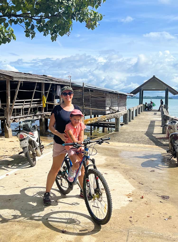 The Village Coconut Island Resort Review - bike hire - mother and daughter on the bicycle in the local village at Coconut Island