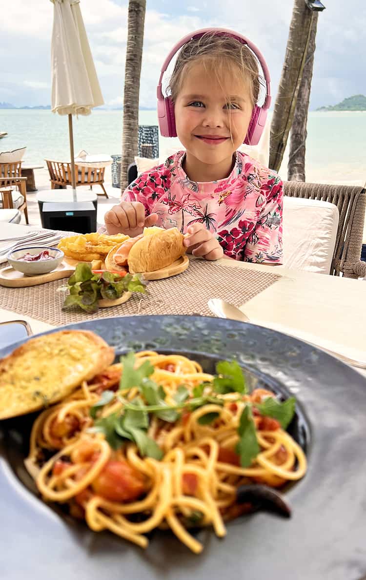 The Village Coconut Island Resort Review - girl eating pasta and a hot dog at Kabang Restaurant and Bar