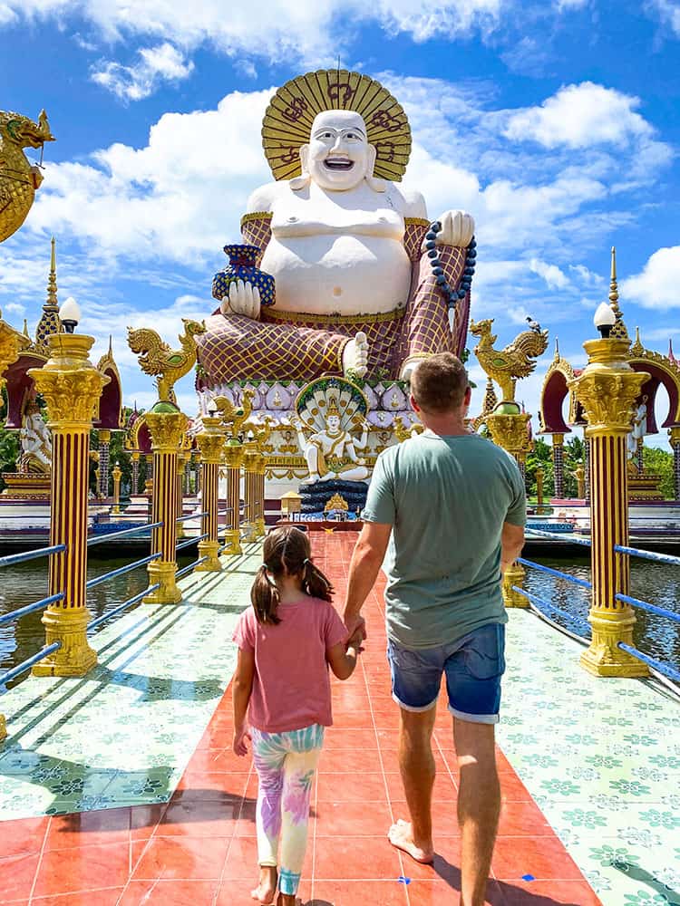 Wat Plai Laem temple, Koh Samui, Thailand, father and daughter walking towards the statue of the big buddha, very colourful