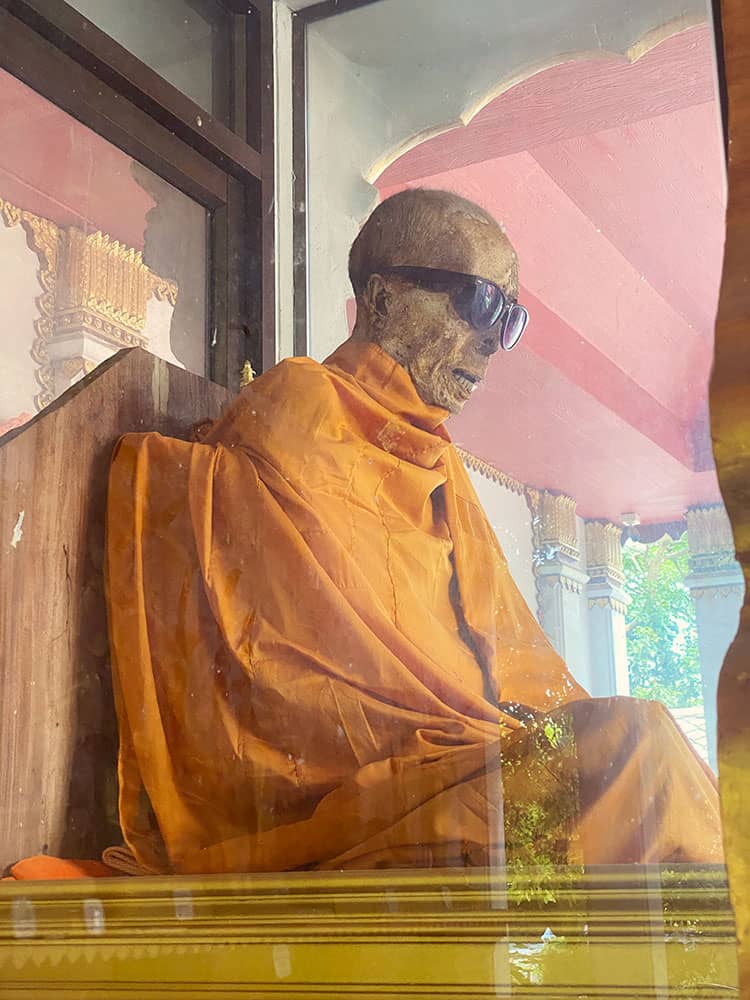  Mummified Monk, Koh Samui, Thailand, temple, mummy of the monk in a sitting position, behind the glass box, sunglasses covering eyes