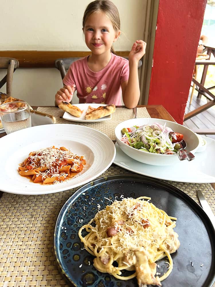 Best Italian Restaurants in Koh Samui -  Girl sitting behind the table with Pasta on the plate at Gusto Italiano Koh Samui