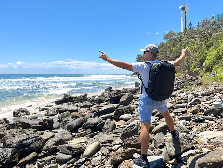OUTWALK 1.0 a Stylish Travel Back Pack Review - Man with the backpack on the rocky beach