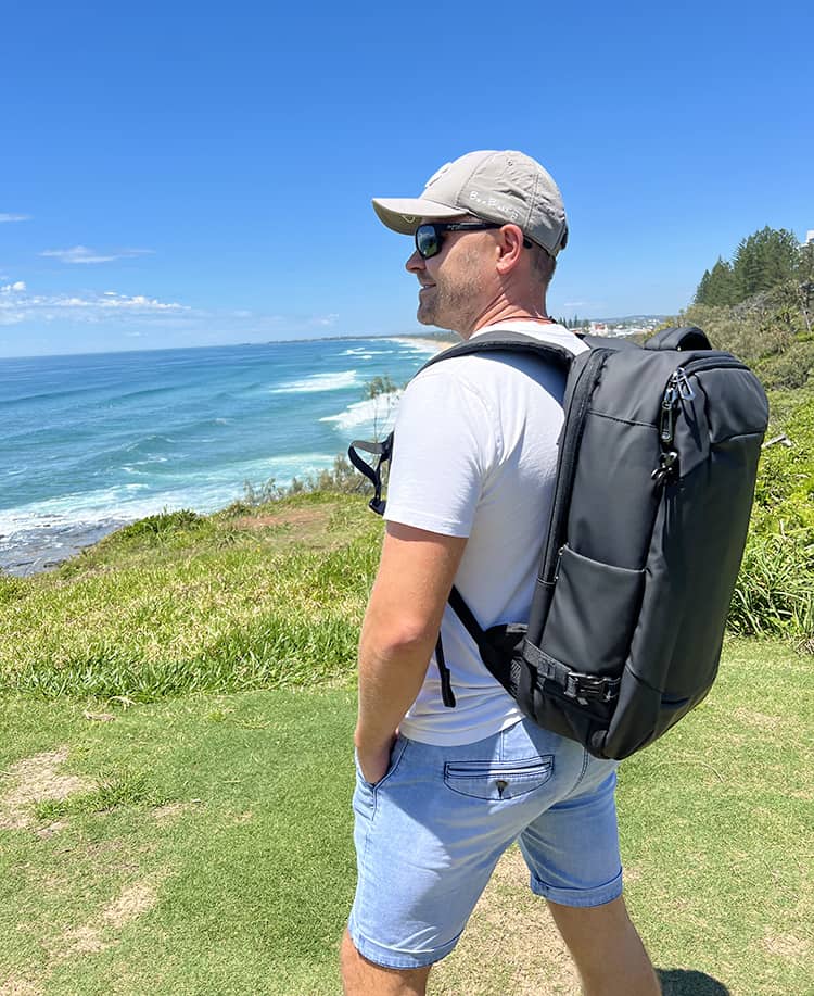 OUTWALK 1.0 a Stylish Travel Back Pack Review - Man with the backpack, side view, staring out into the ocean