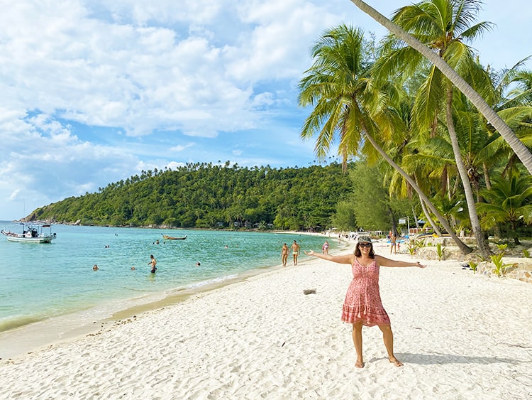 Koh Samui or Koh Phangan, Salad Beach in Koh Phangan, lady with arms up standing in the sand on the beach