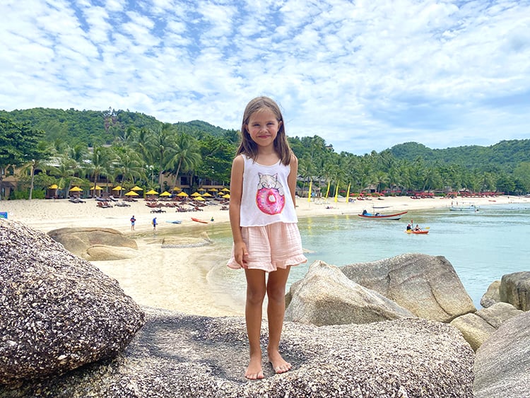 Thong Nai Pan Noi Beach Koh Phangan, young girl standing on the rock with beach in the background