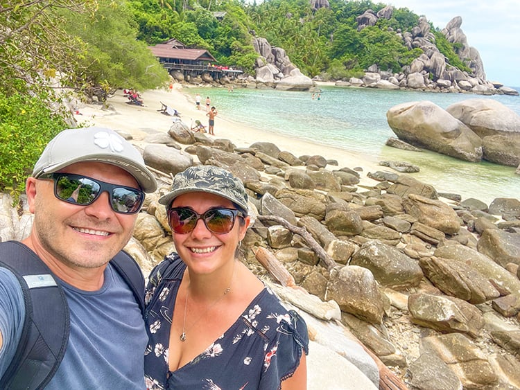 Best Beaches in Koh Tao Thailand - Freedom Beach, couple at the rocks, beach in background