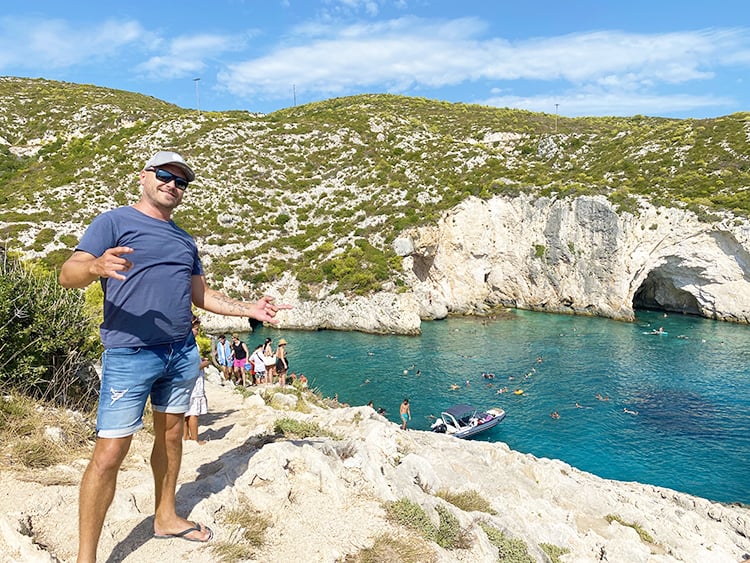 Places to see in Zakynthos Greece - Porto Limnionas, man standing on the rocks