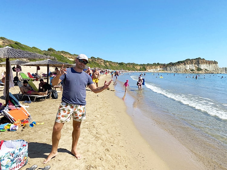 Things to do in Zakynthos Greece - Gerakas Beach, man on the beach, beach chairs, umbrellas
