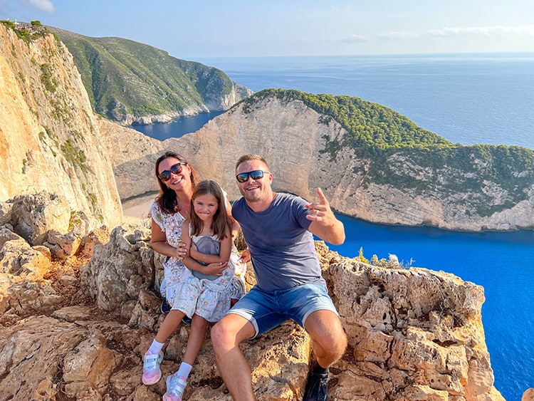 Top Tips for Planning a Family Holiday- Family on the rocks Navagio Shipwreck Beach Lookout