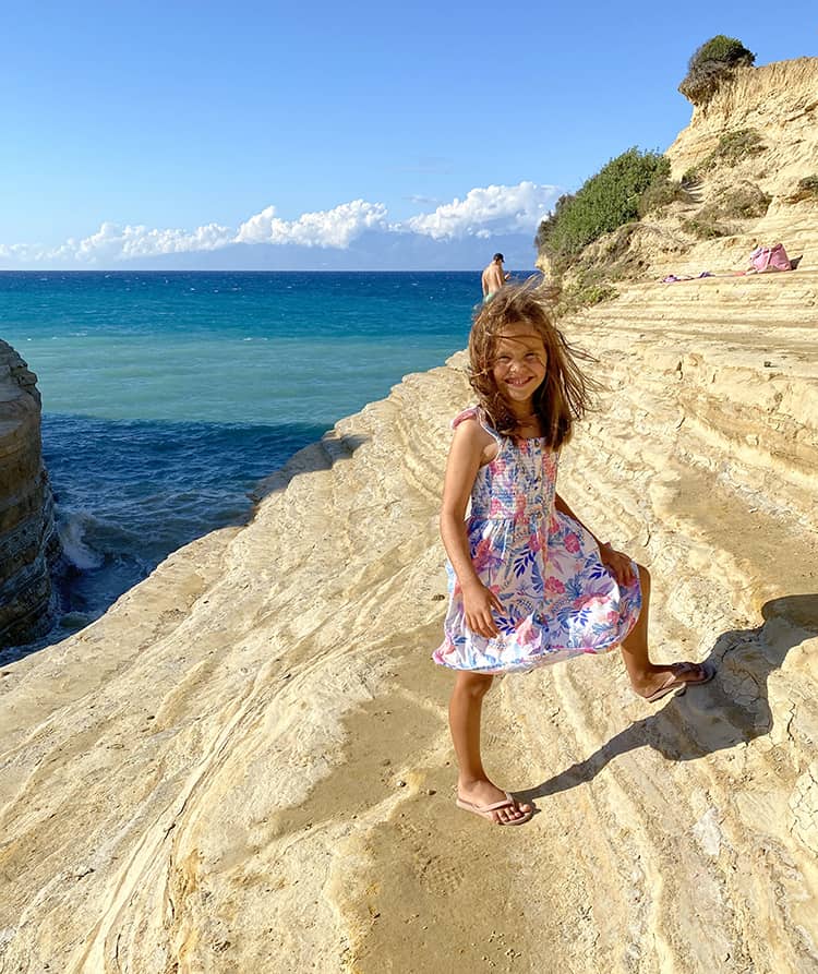 Canal d'Amour in Corfu, Greece, young girl on the rocky side of the canal