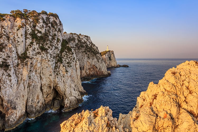 Doukato Lighthouse in Lefkada, Greece, view of the lighthouse in far distance, rocky water front