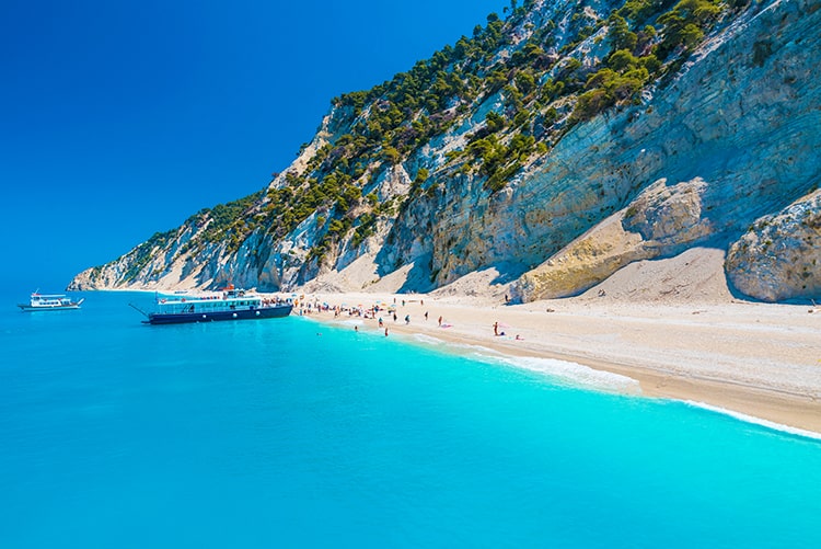 Egremni Beach Lefkada Greece, boat and people at the beach