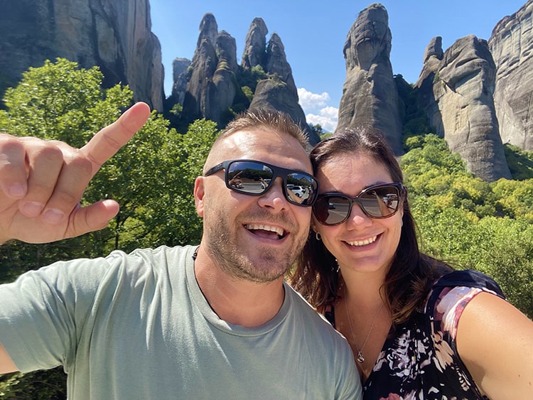 Meteora Monasteries in Greece, a couple with Meteora Rocks in background