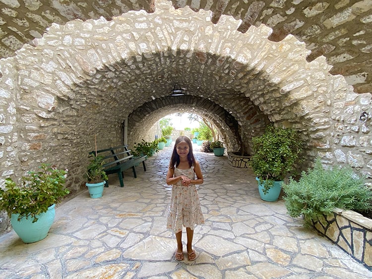 Paleokastritsa Monastery in Corfu, Greece, young girl at the monastery