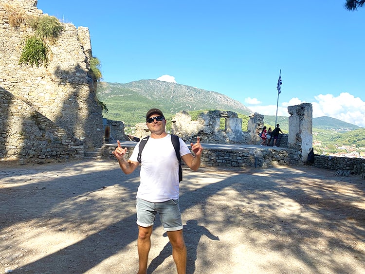 Parga Travel Guide - Venetian Castle of Parga - man standing in front of the ruins of the Parga Castle