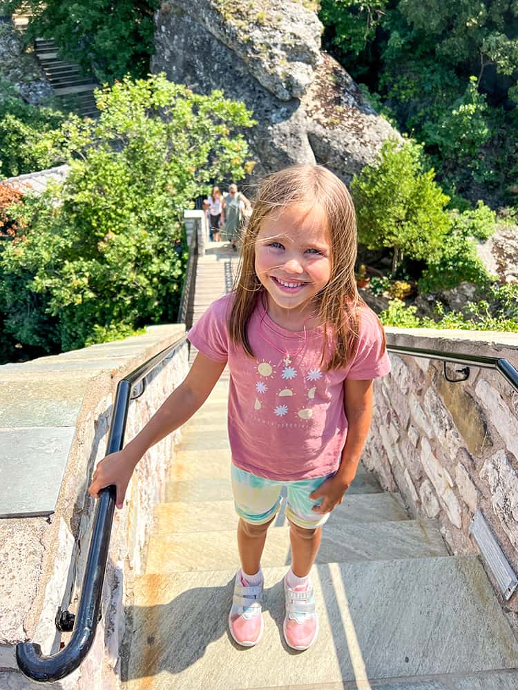 Roussanou Monastery Meteroa, Greece, young girl climbing the stairs up to the monastery