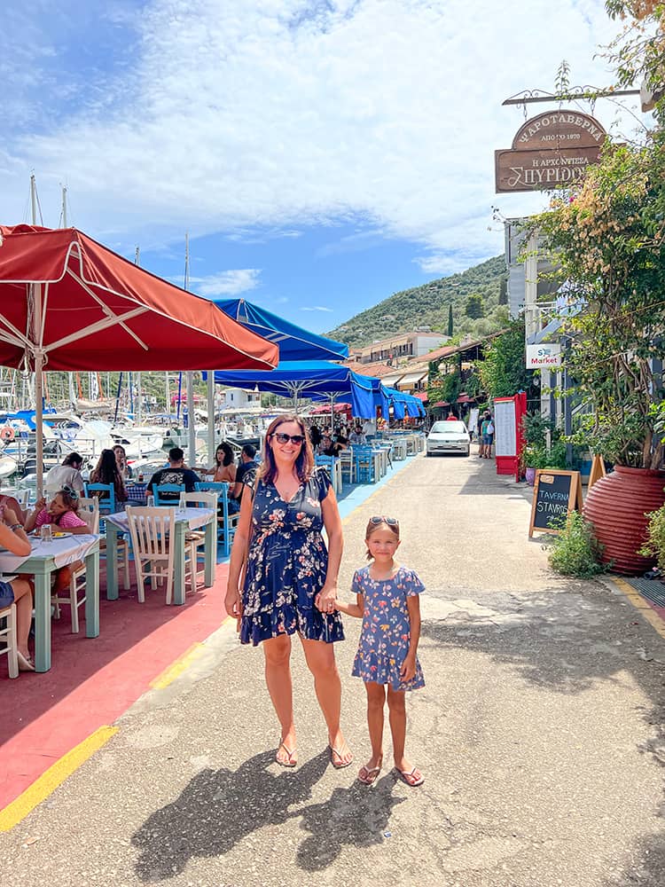 Sivota in Lefkada Island in Greece, mother and daughter standing close to restaurants