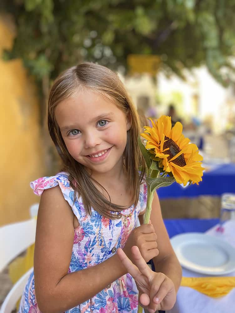 Best places to visit in Crete, Greece, Chania Old Town, Turkish Quarter, young girl with a flower