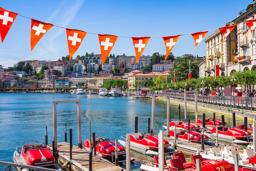 Panorama view of the lake Lugano, mountains and city Lugano, Ticino canton, Switzerland. Scenic beautiful Swiss town with luxury villas. Famous tourist destination in South Europe