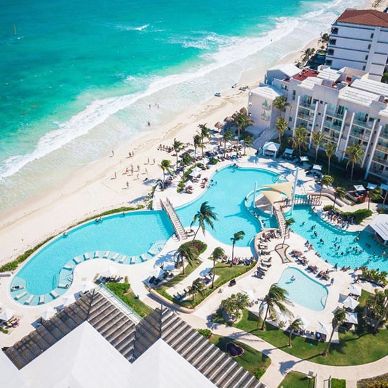 Dreams Jade Resort & Spa in Mexico, aerial view of the resort pools by the beach, square image