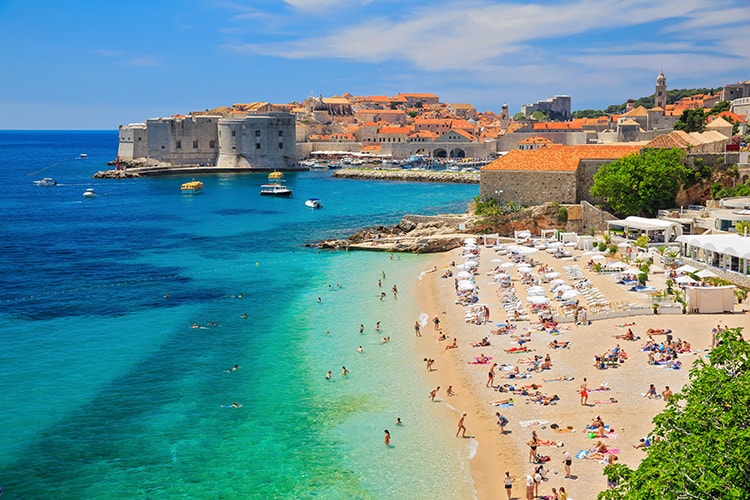 A beach full of people in Dubrovnik in Croatia