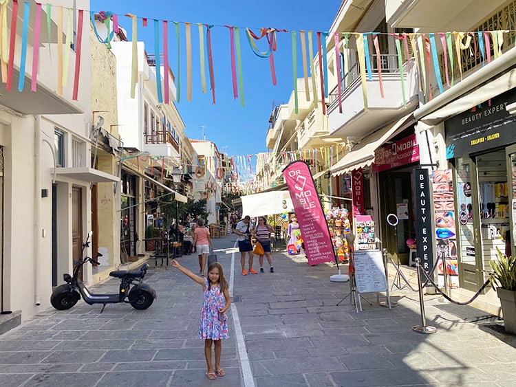 Family Holiday to Crete, Greece, Rehymnon Old Town, shops and old street, young girls arm up