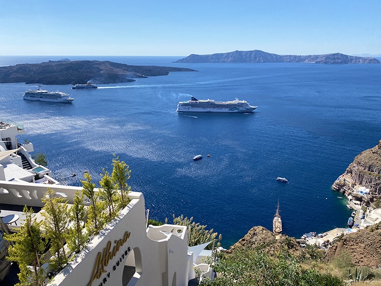 Santorini in September, Greece - Cruise ships in Fira, boats on the water, view from the top of the town