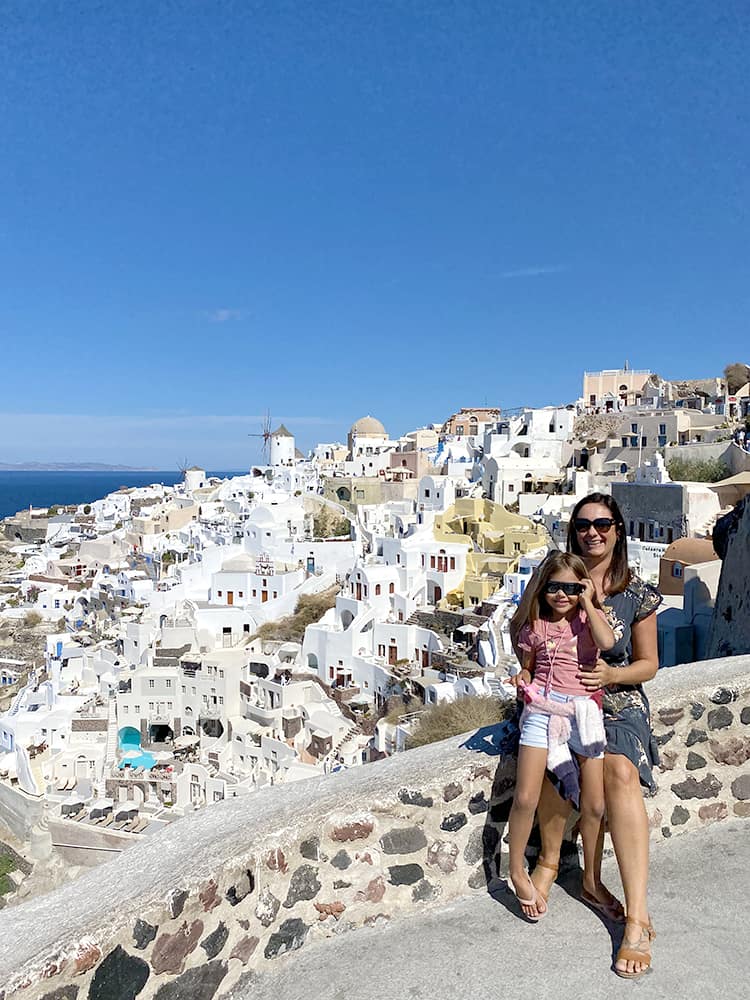 Santorini Greece - Mother and daughter posing at the view point of the OIA old town