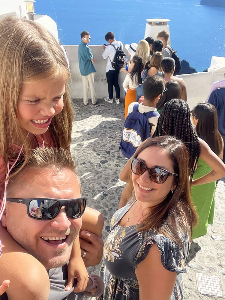 Santorini in September, Greece - family in the line for a photo at the view point at Oia Santorini, Greece