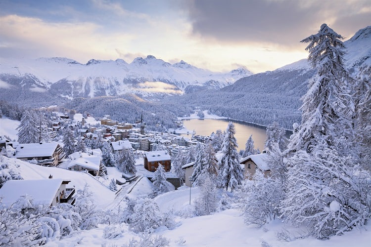 St. Moritz, Switzerland, view of the town from the top, snow covered buildings, trees and mountains