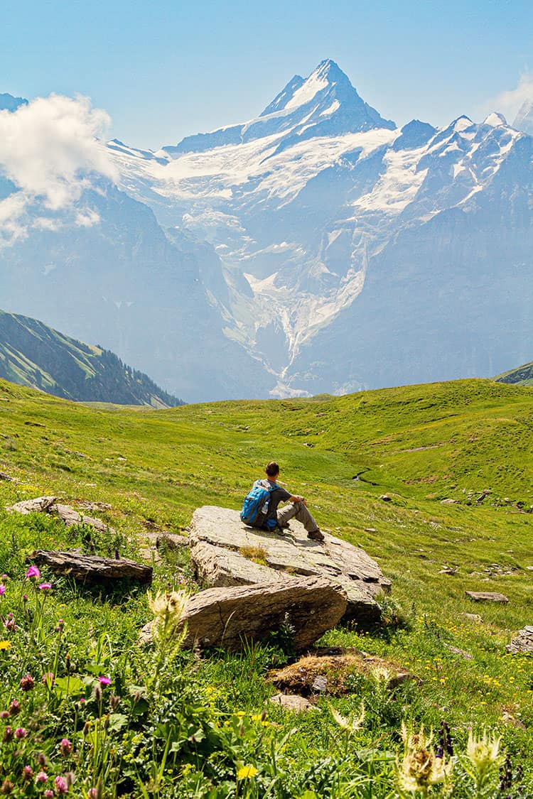 Man sitting on a rock in the Swiss Alps