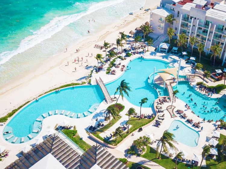 Dreams Jade Resort & Spa in Mexico, aerial view of the resort pools by the beach, feature