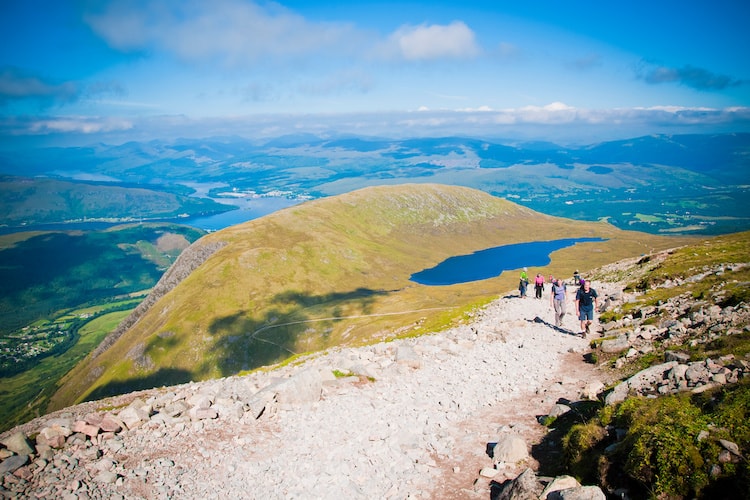 Hikers walking on path of ascent to Mount Ben Nevis, highest peak in the United Kingdom