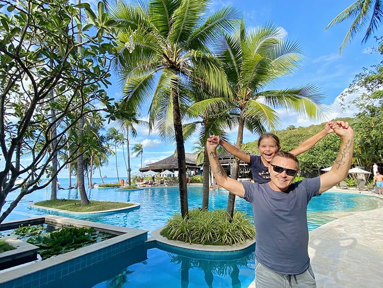 Planning a Family Summer Holiday- Father and Child Standing Poolside on Summer Trip