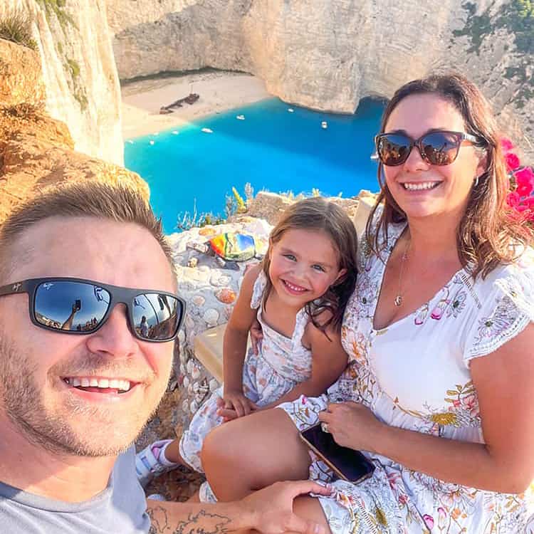 Things to do in Zakynthos Shipwreck Beach View Point family at the lookout Navagio Beach Greece