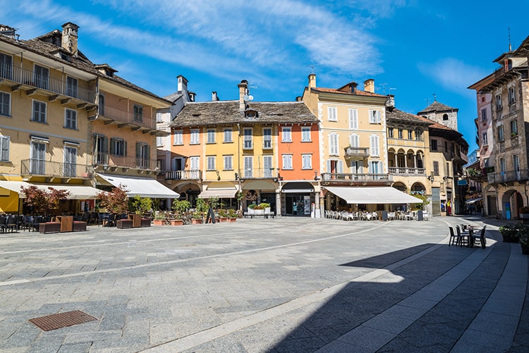 Ancient square in an old city in Europe. Domodossola, city in northern Italy, historic center with bars, cafe, shops and colorful houses. Square del Mercato (piazza del Mercato)