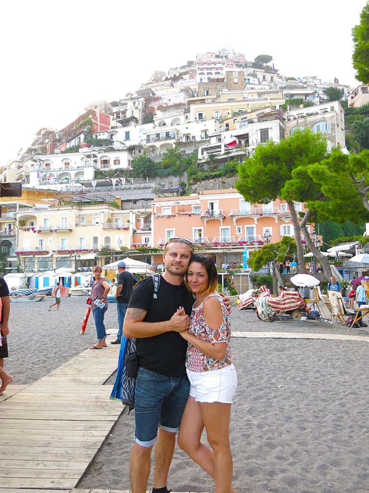 Best Pompeii Day Trips from Rome, a couple on the Positano Amalfi Coast main beach